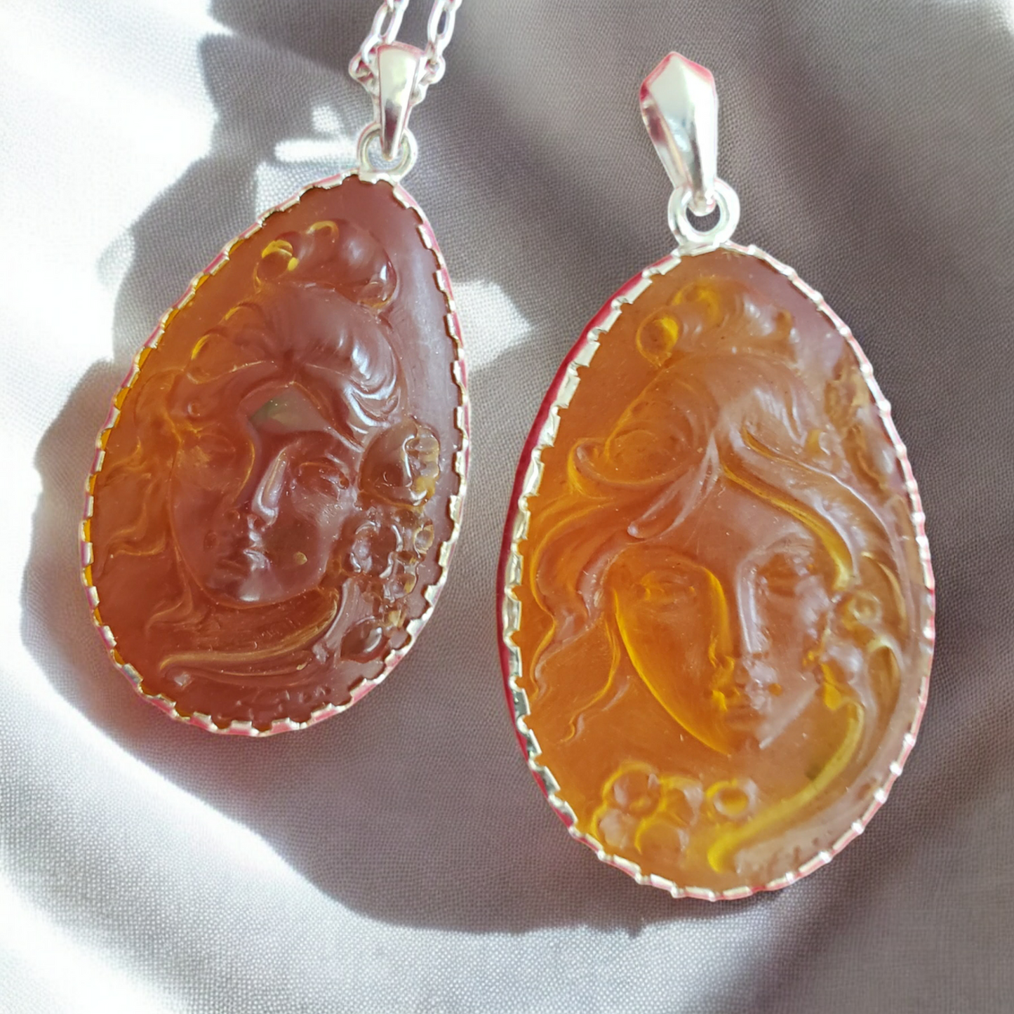 Two Italian Carved Dominican Amber Cameo Pendanta