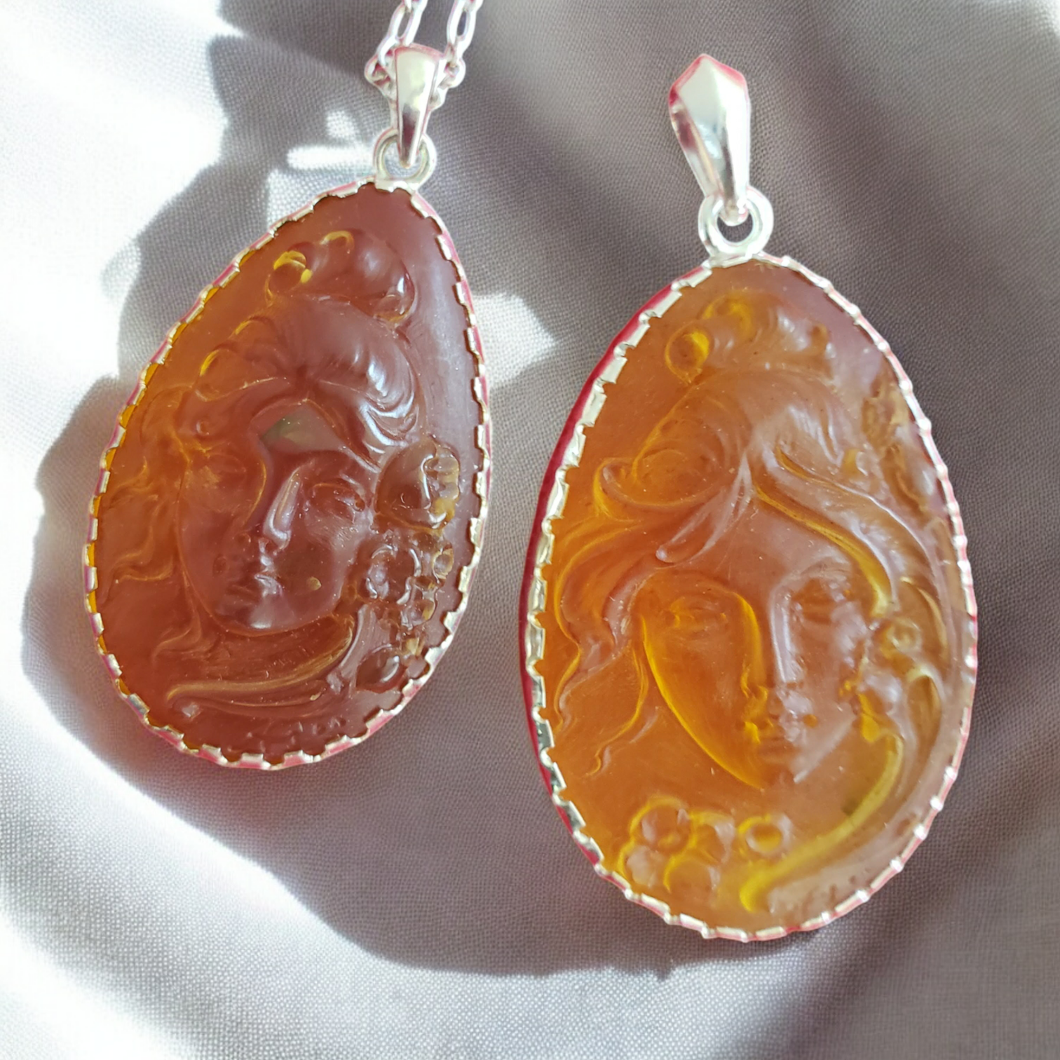 Two Italian Carved Dominican Amber Cameo Pendanta
