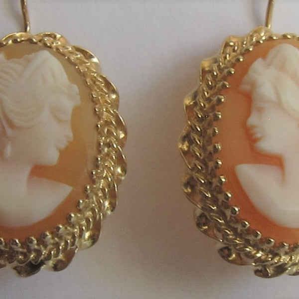 Close up of natural carved shell Cameo earring in 14 karat yellow gold.  